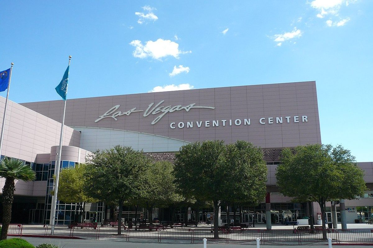 Las Vegas convention center exterior at dusk with neon city glow