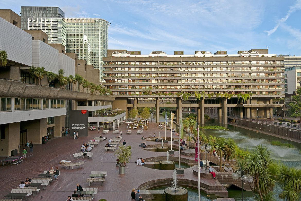 Brutalist London performing-arts venue at blue hour with reflecting pool